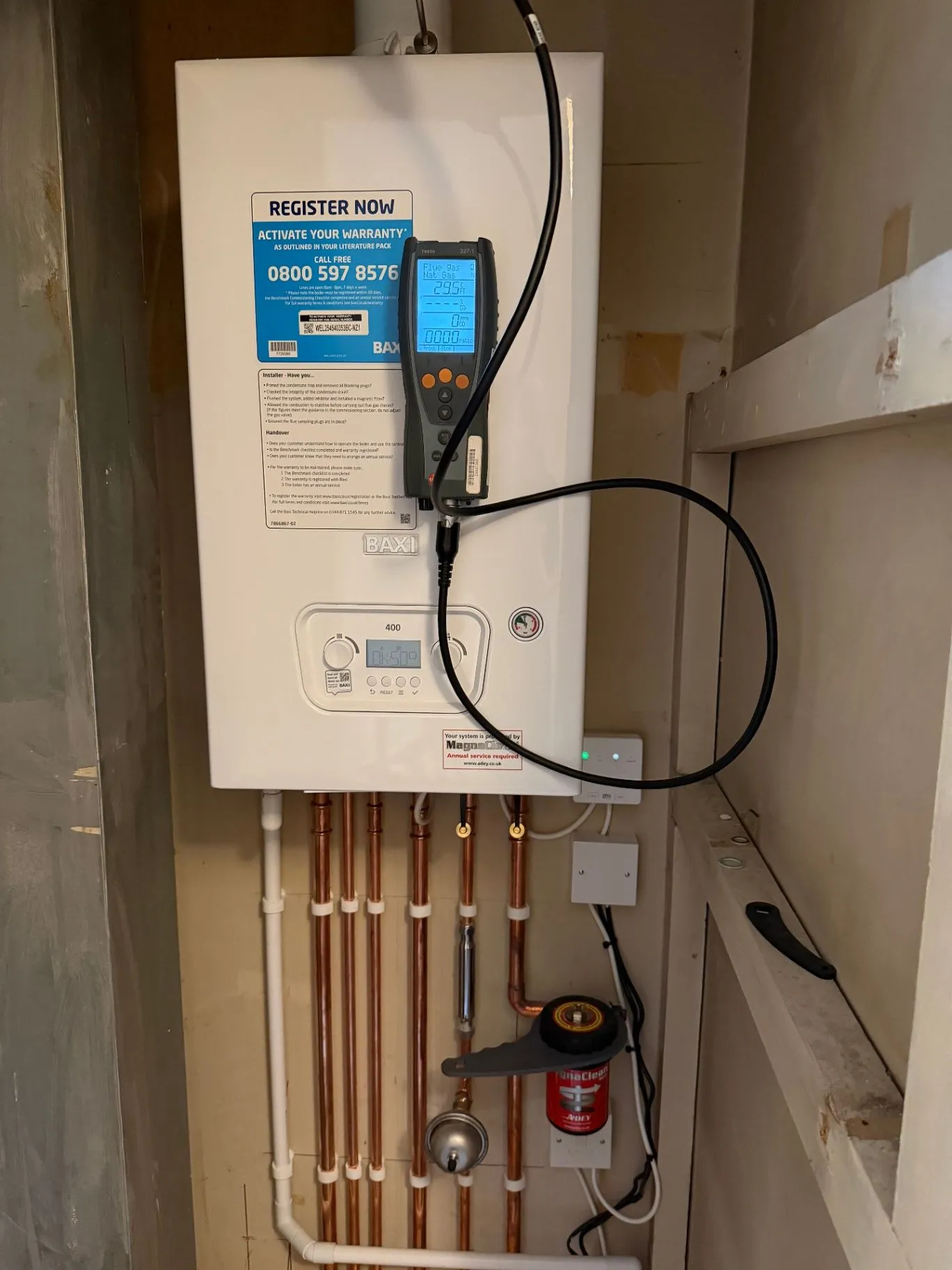 Wall-mounted boiler with a service analyser and copper pipework below